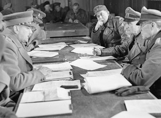 Charles Foulkes (left) faces General Paul Reichilt (right) during a conference