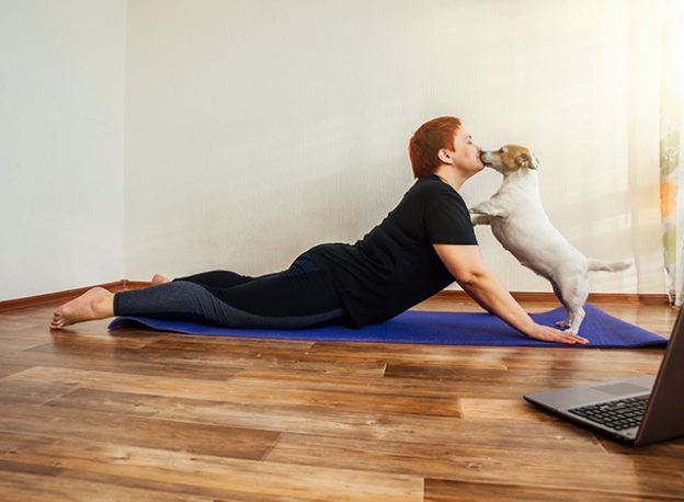 Lady doing yoga with her dog