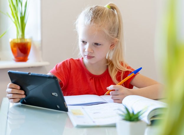 Young girl doing school work from home