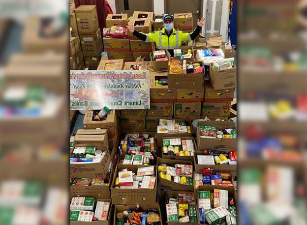 Paramedic Jason Tunks standing with the food donations!