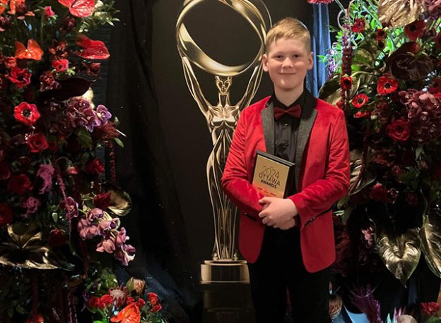 Finn Vanderlinden holding his 2024 Ottawa award.