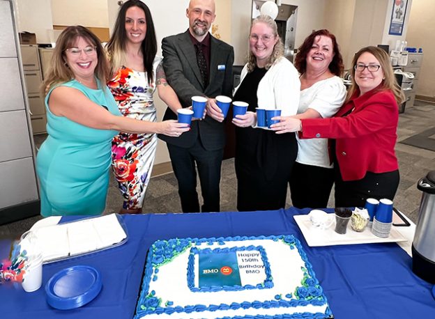 Smiths Falls BMO staff celebrate with cake.