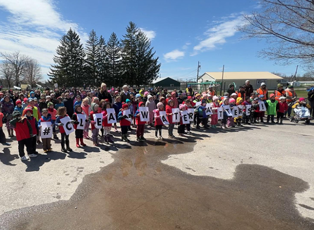 The Queen Elizabeth School students holding signs that spell #CleanWaterMatters!